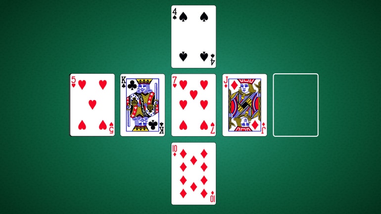 five cards in a cross pattern on a poker table
